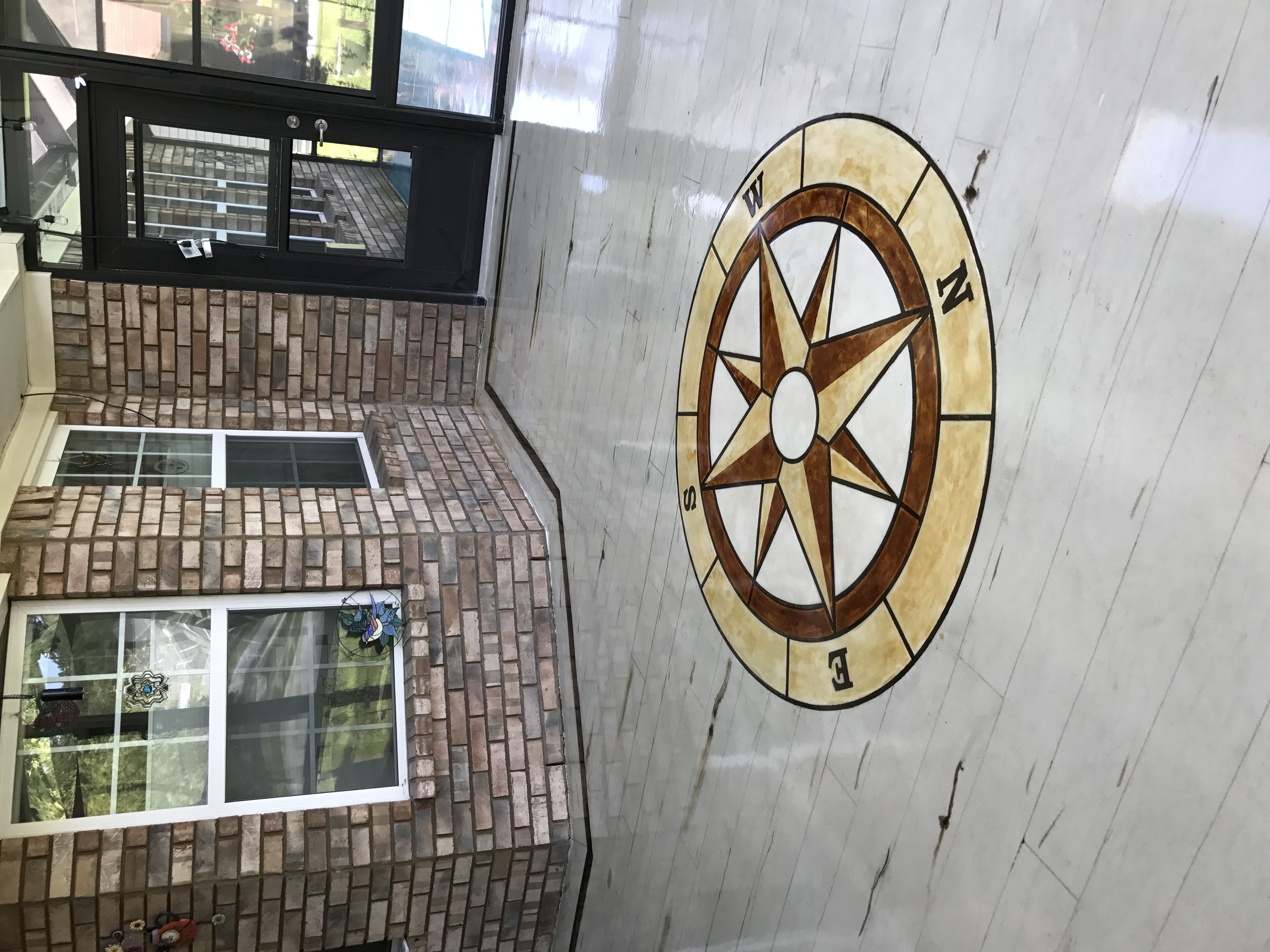 Marble epoxy floor with compass rose design in commercial lobby