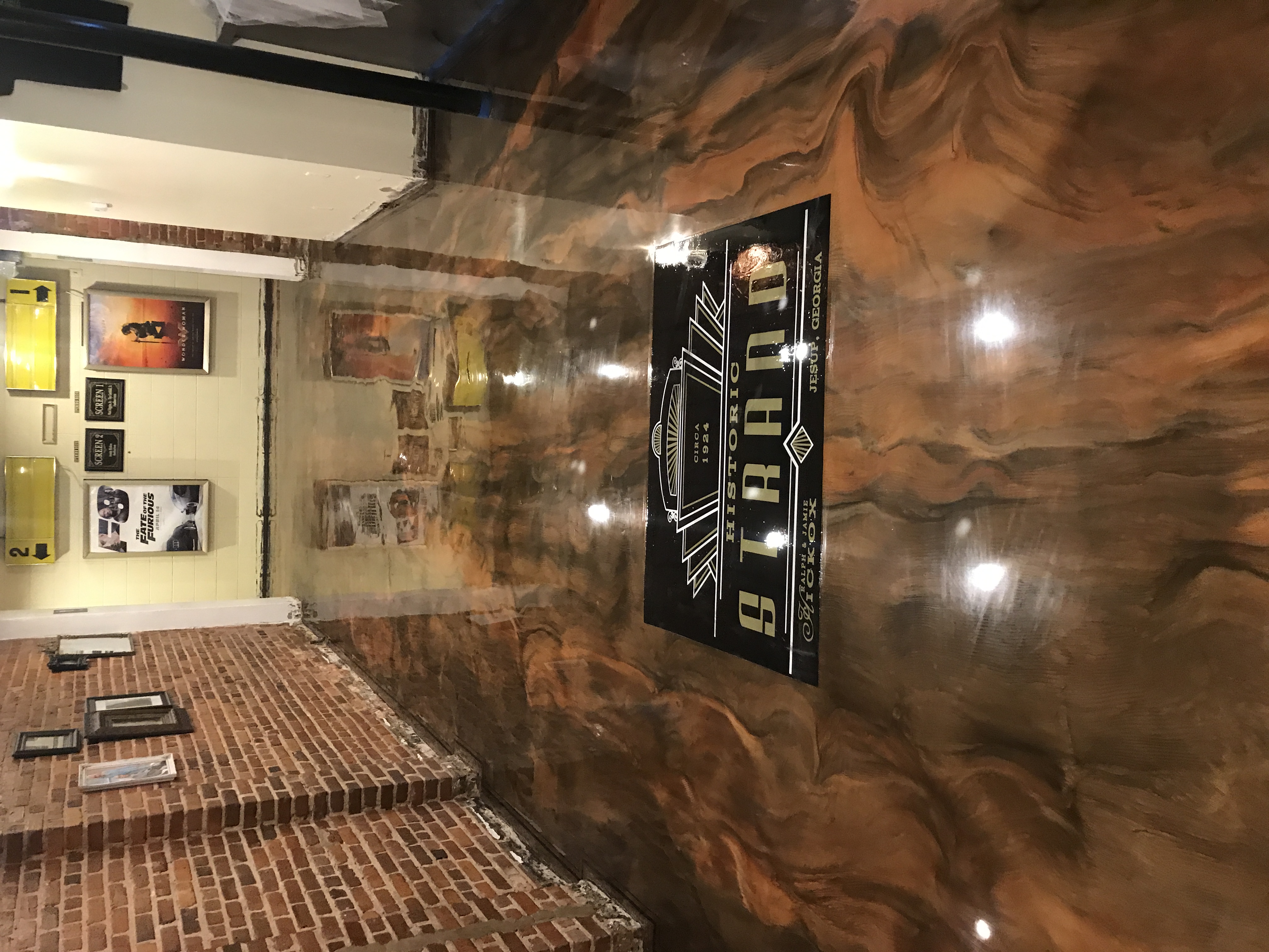 Commercial metallic epoxy flooring in theater lobby